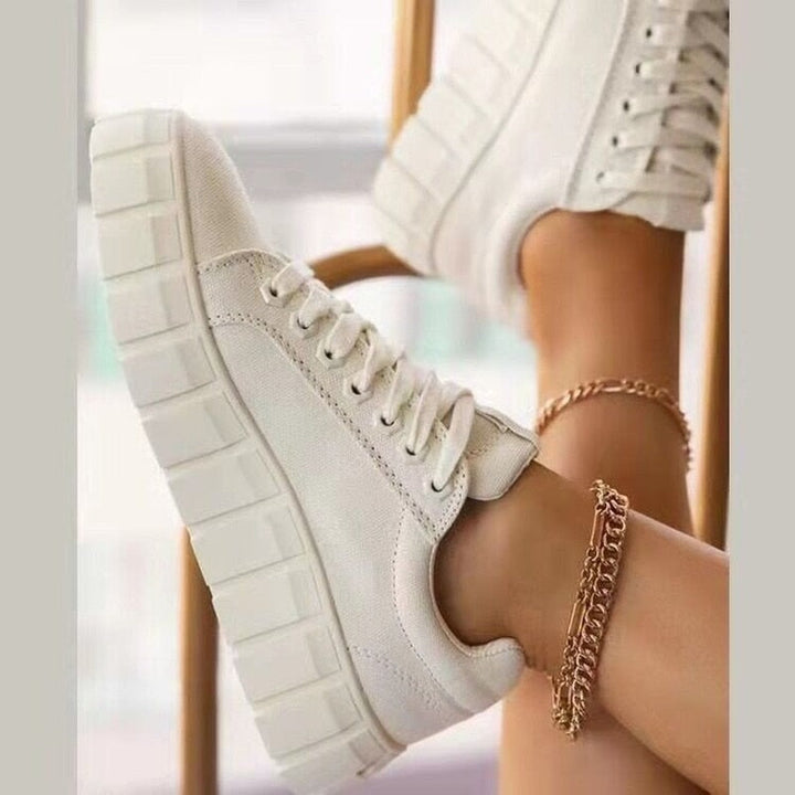 Model wearing women's everyday comfort low top sneakers with jeans.