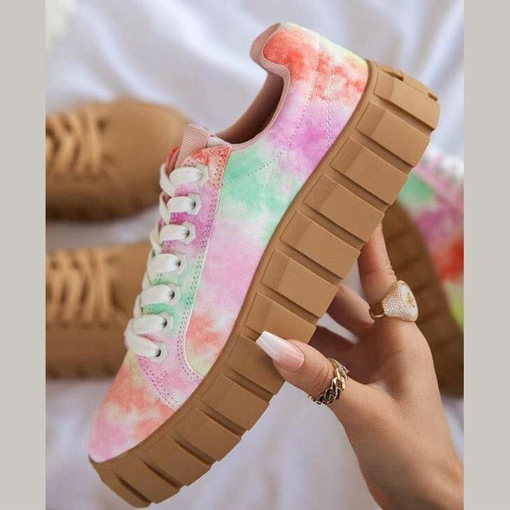 Pair of women's versatile low top sneakers in a neutral color, great for any activity.