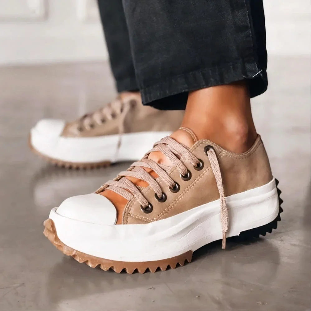Lace-up women's platform sneakers, low-top design with a comfy chunky sole for supportive walking.
