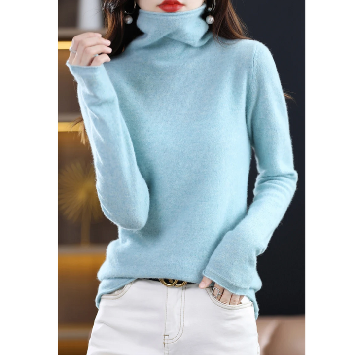 Showcasing the flattering fit of the women's luxe roll neck sweater