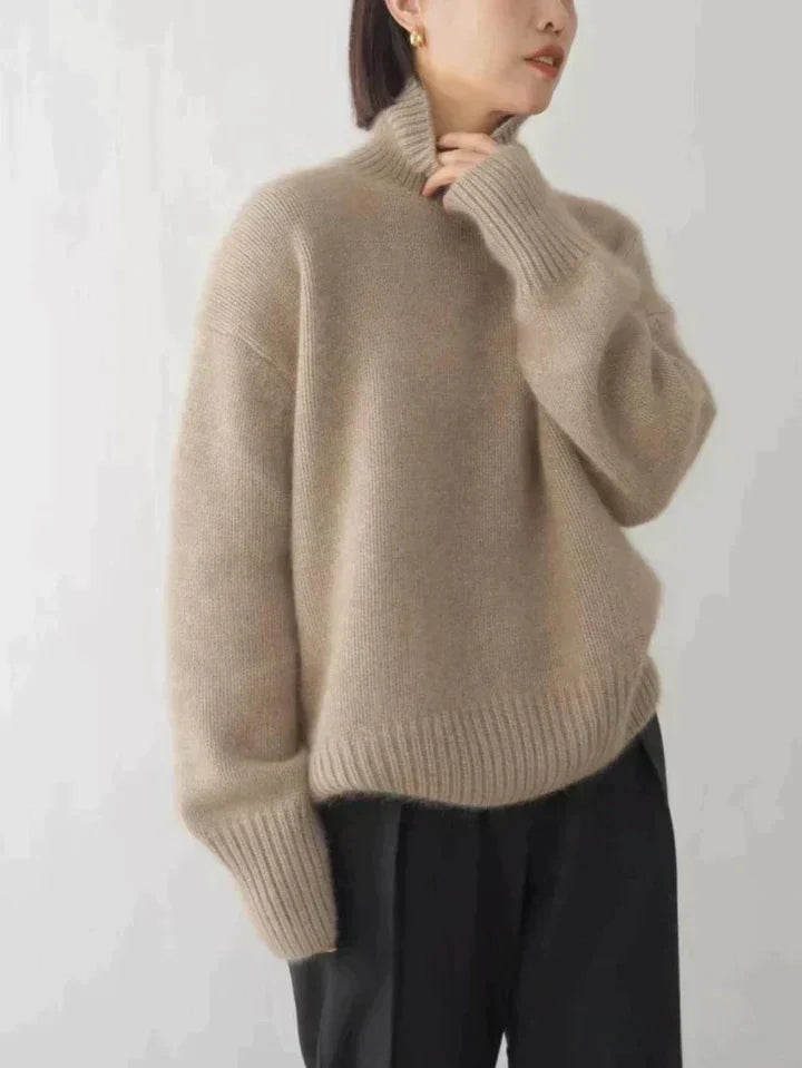 Women's luxe turtleneck sweater in soft knit fabric, perfect for cozy layering.
