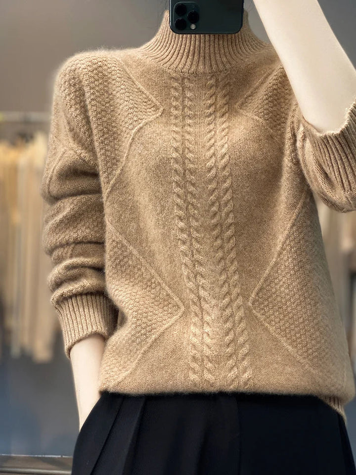 Front view of a women's cable knit cashmere jumper, highlighting the roll neck.