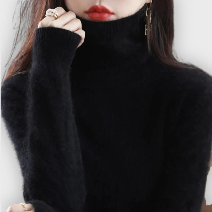 Detail shot of the fine ribbing on a women's luxury cashmere turtleneck top.