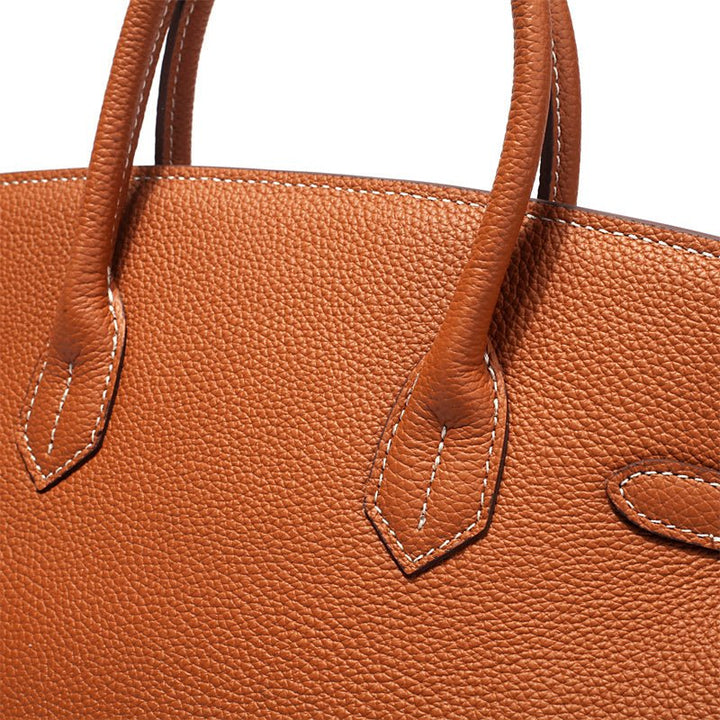 Chic leather handbag with top handle, cognac, luxury design