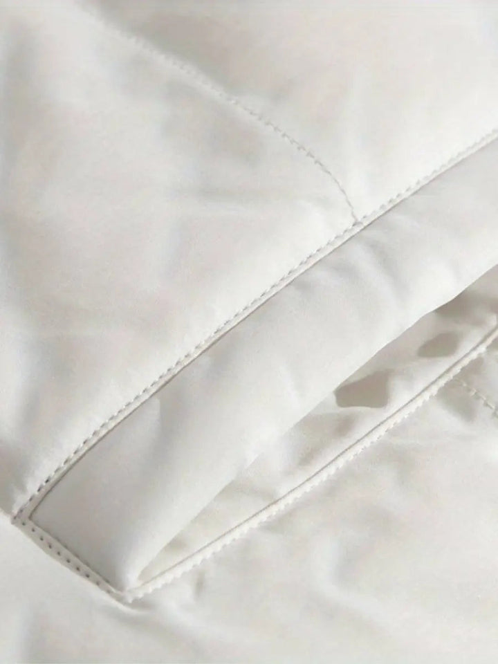 Luxury women's hooded puffer jacket, designed for warmth and comfort in winter.
