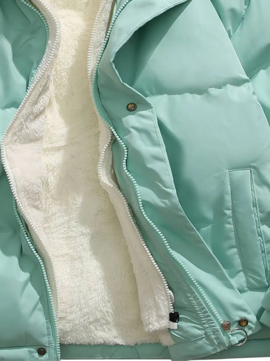Luxurious women's puffer jacket, hooded and padded for superior winter warmth and style.