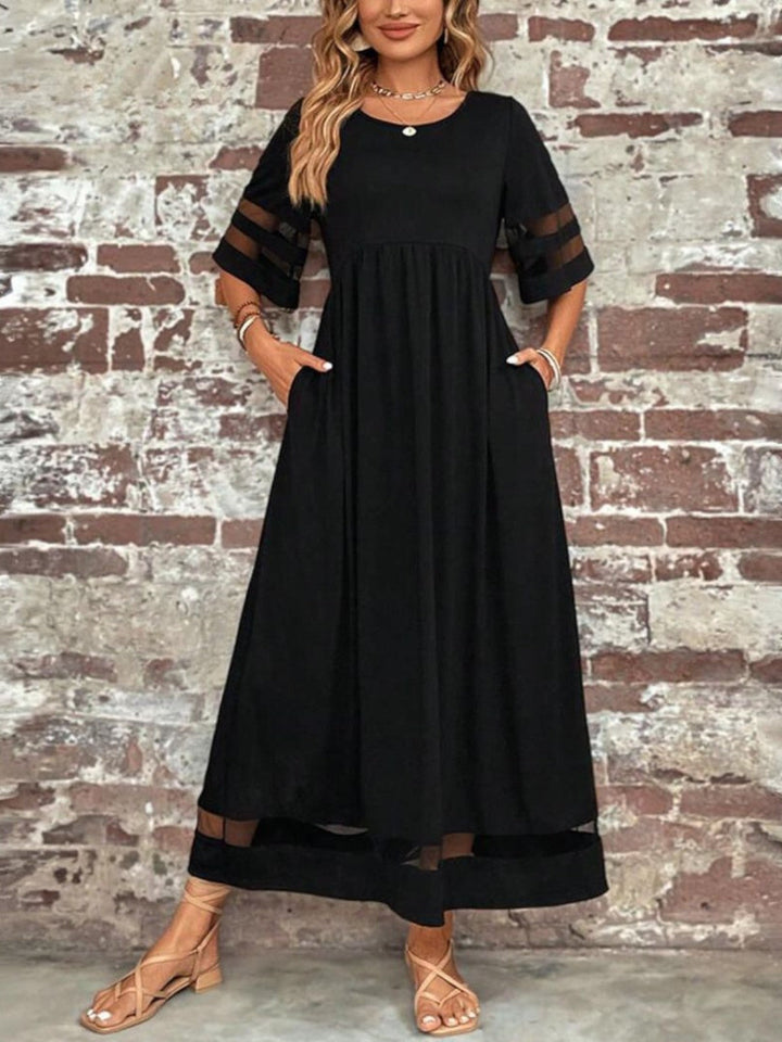 Elegant women's mesh panel midi dress with half sleeves, perfect for a casual summer or evening look.