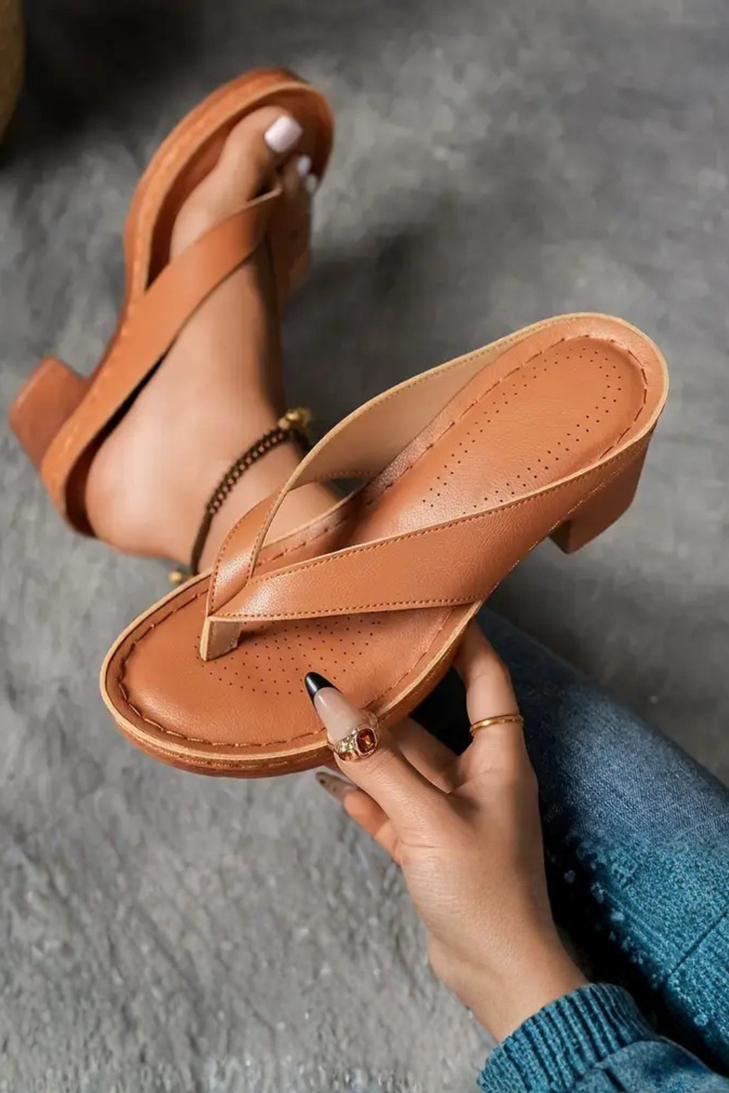Fashionable women's block heel sandals, featuring a metallic toe post and comfortable design.