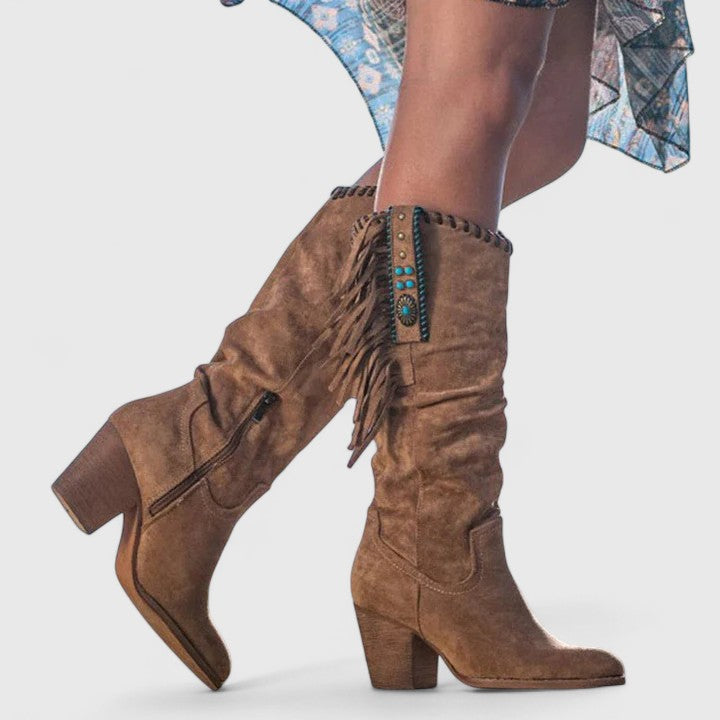 Close-up: Women's mid-calf boots featuring intricate fringe detail & sturdy block heel.