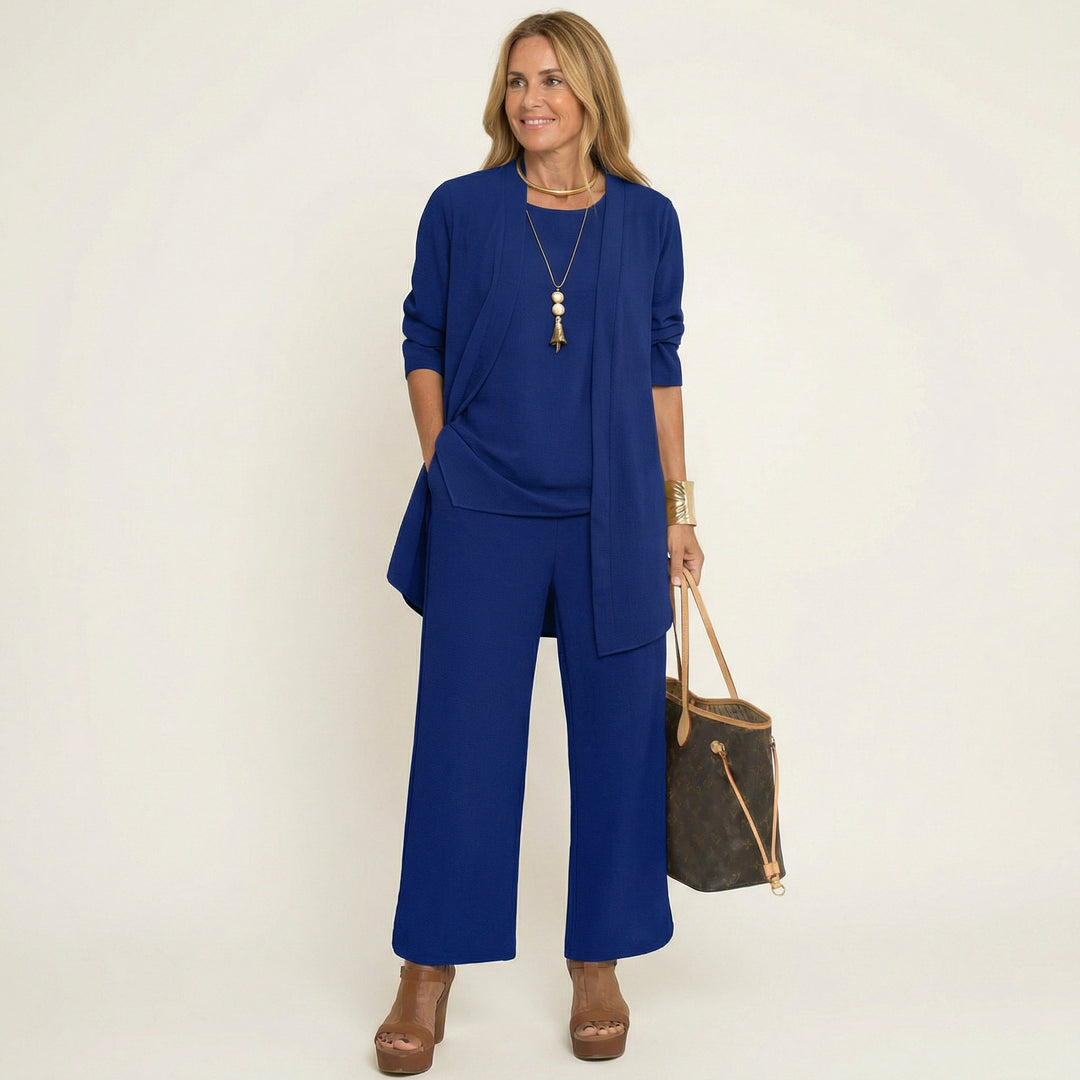 Comfortable women's travel outfit: minimalist vest, blouse & wide-leg pants matching set.
