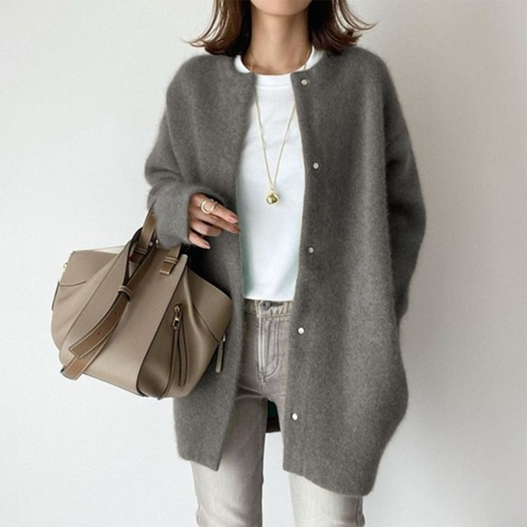 Effortless style with this women's button cardigan; longline cut, versatile for casual or dressed-up occasions.