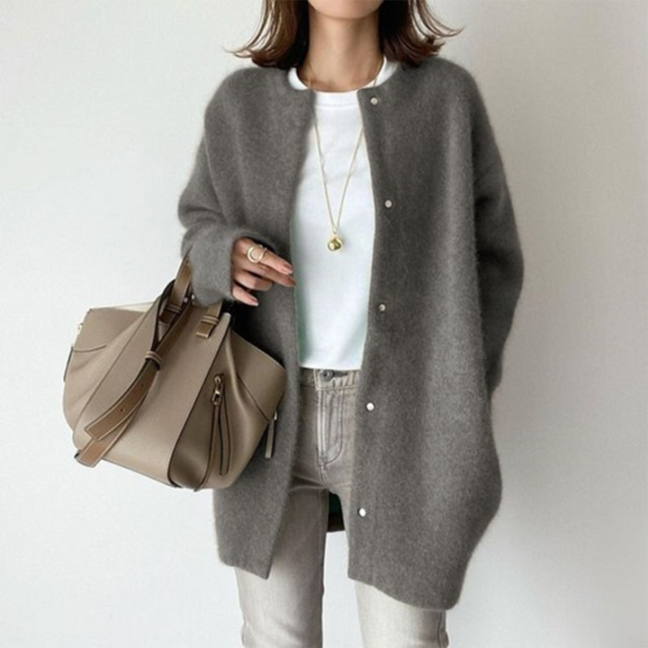 Effortless style with this women's button cardigan; longline cut, versatile for casual or dressed-up occasions.