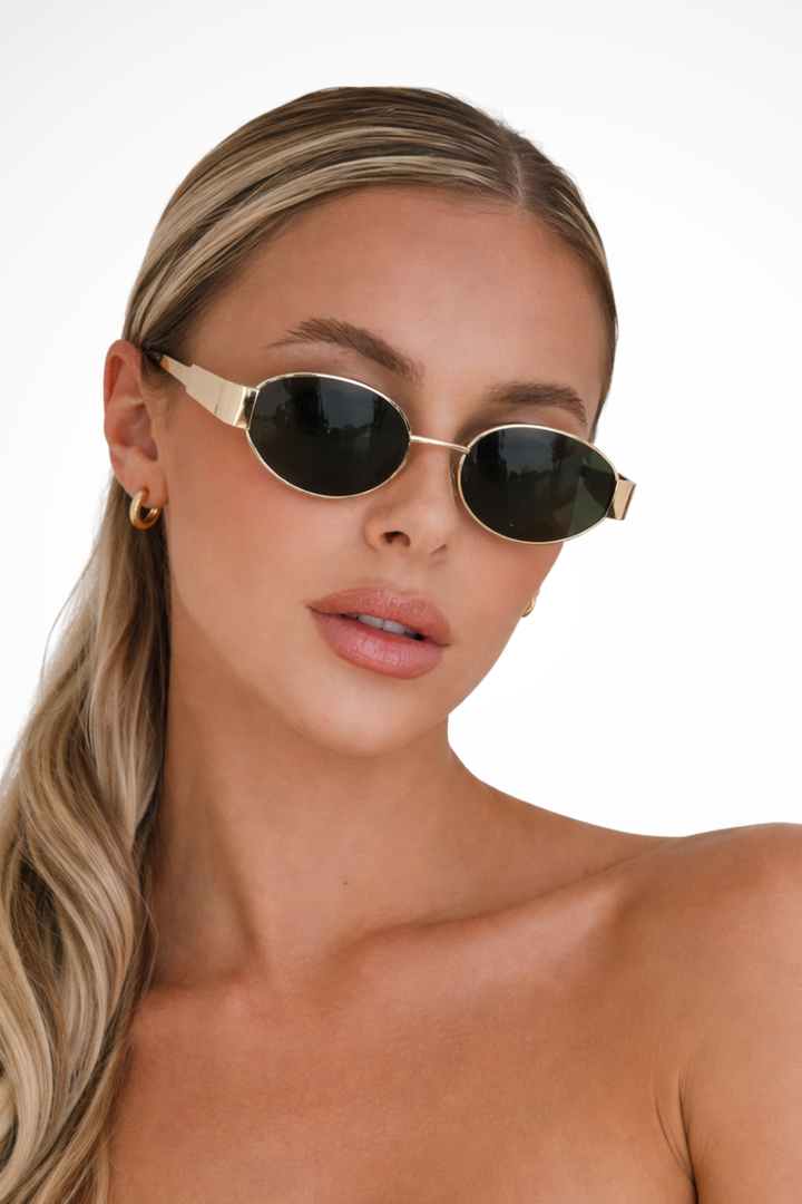 Women's minimalist oval metal frame sunglasses with dark lenses. Elegant & lightweight chic eyewear.