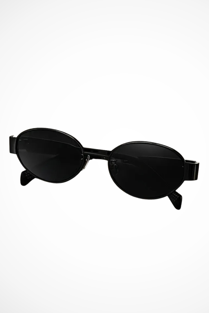 Women's oval sunglasses, metal frame, dark lenses. Minimalist, lightweight & chic fashion accessory.