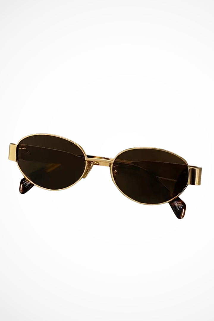 Minimalist women's oval sunglasses. Lightweight metal frame & dark lenses for a chic, elegant look.