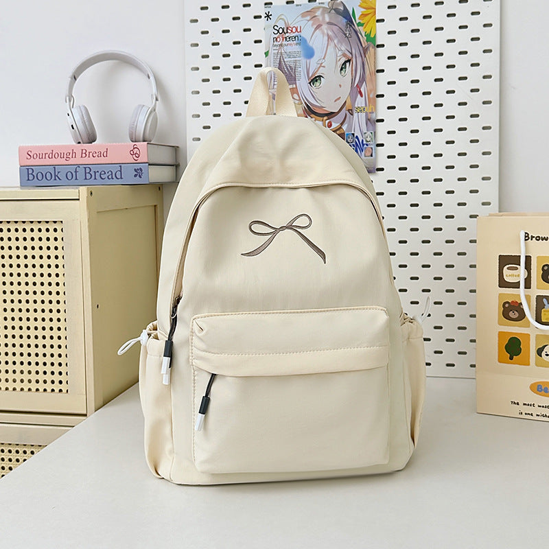 Elegant women's student backpack for school & daily carry. Minimalist design with a fashionable bow accent.