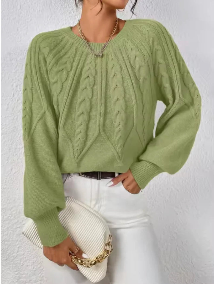 Women's modern cable knit sweater, crew neck, long voluminous sleeves. Chic and cozy knitwear.