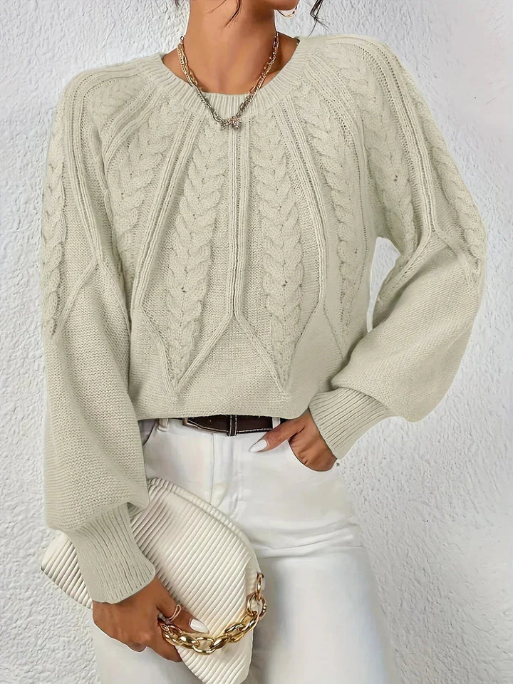 Cozy women's cable knit sweater featuring stylish voluminous long sleeves and a classic crew neck.