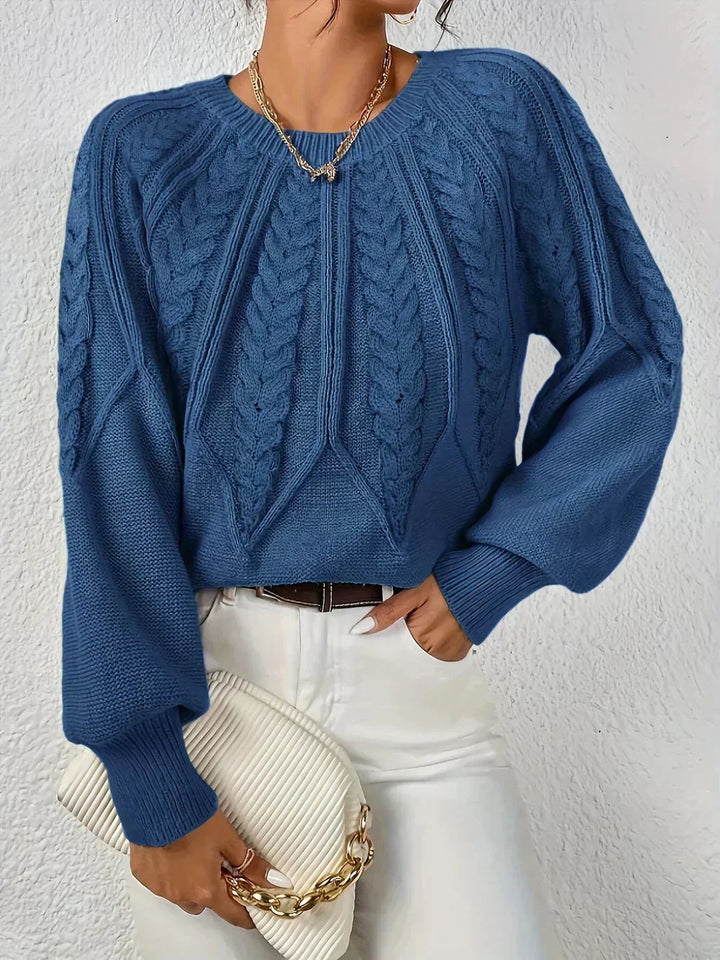 Modern women's cable knit sweater. Soft knit fabric, crew neck, and trendy voluminous long sleeves for comfort.
