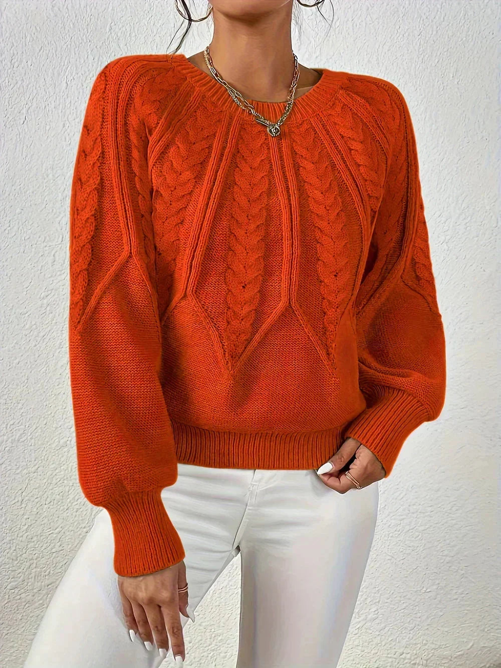 Versatile women's long sleeve cable knit sweater with a modern design and voluminous sleeves. Perfect for chic outfits.