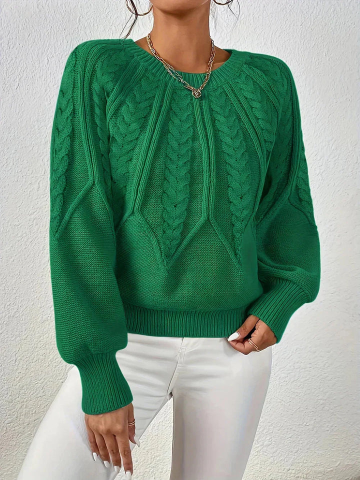 Warm women's cable knit sweater. Intricate knit pattern, cozy feel, and elegant voluminous long sleeves.