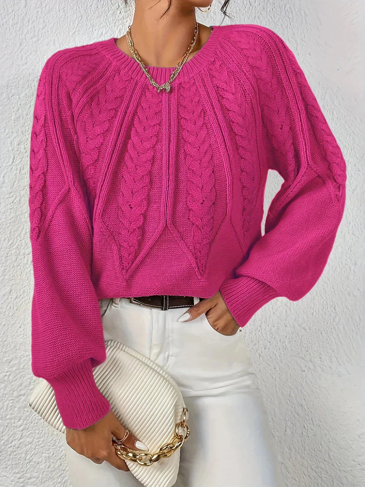 Stylish women's cable knit sweater with a crew neck and fashionable voluminous long sleeves. A modern wardrobe essential.
