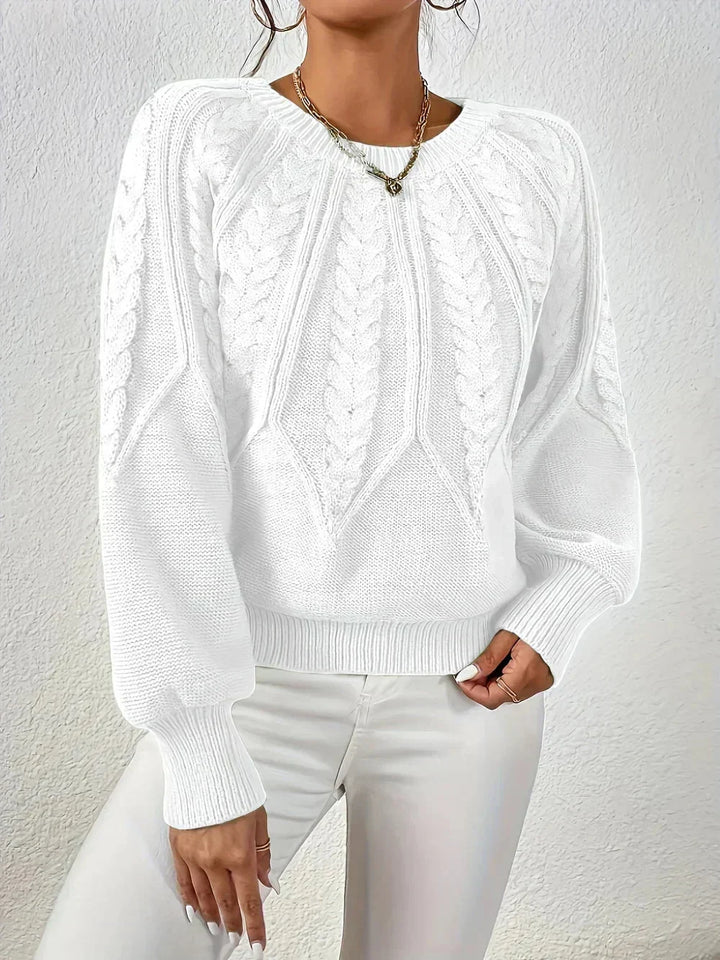 Comfortable women's knit sweater featuring a classic cable pattern, crew neck, and chic voluminous sleeves.