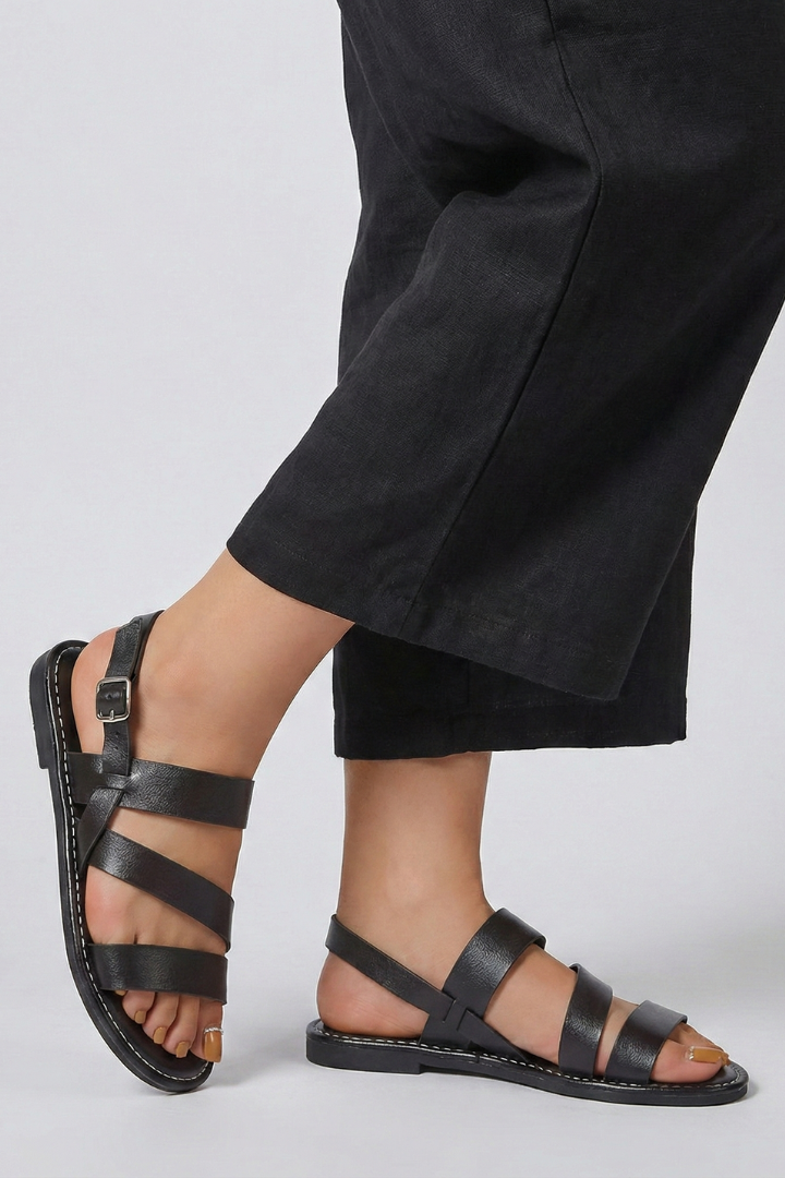 Stylish women's flat sandals, modern aesthetic & secure back strap. Essential summer footwear.