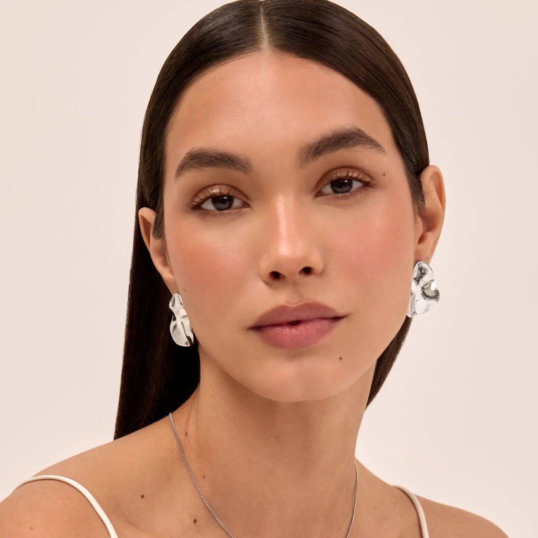 Close-up of women's modern geometric stud earrings, a chic and versatile accessory.