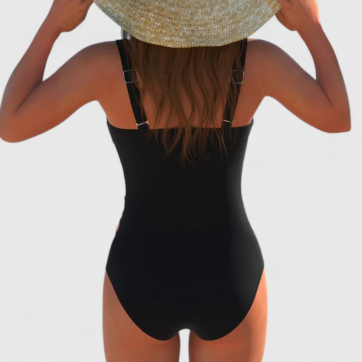 Flattering women's modern printed swimsuit. Ideal one-piece beachwear for vibrant summer vacations & resort wear.