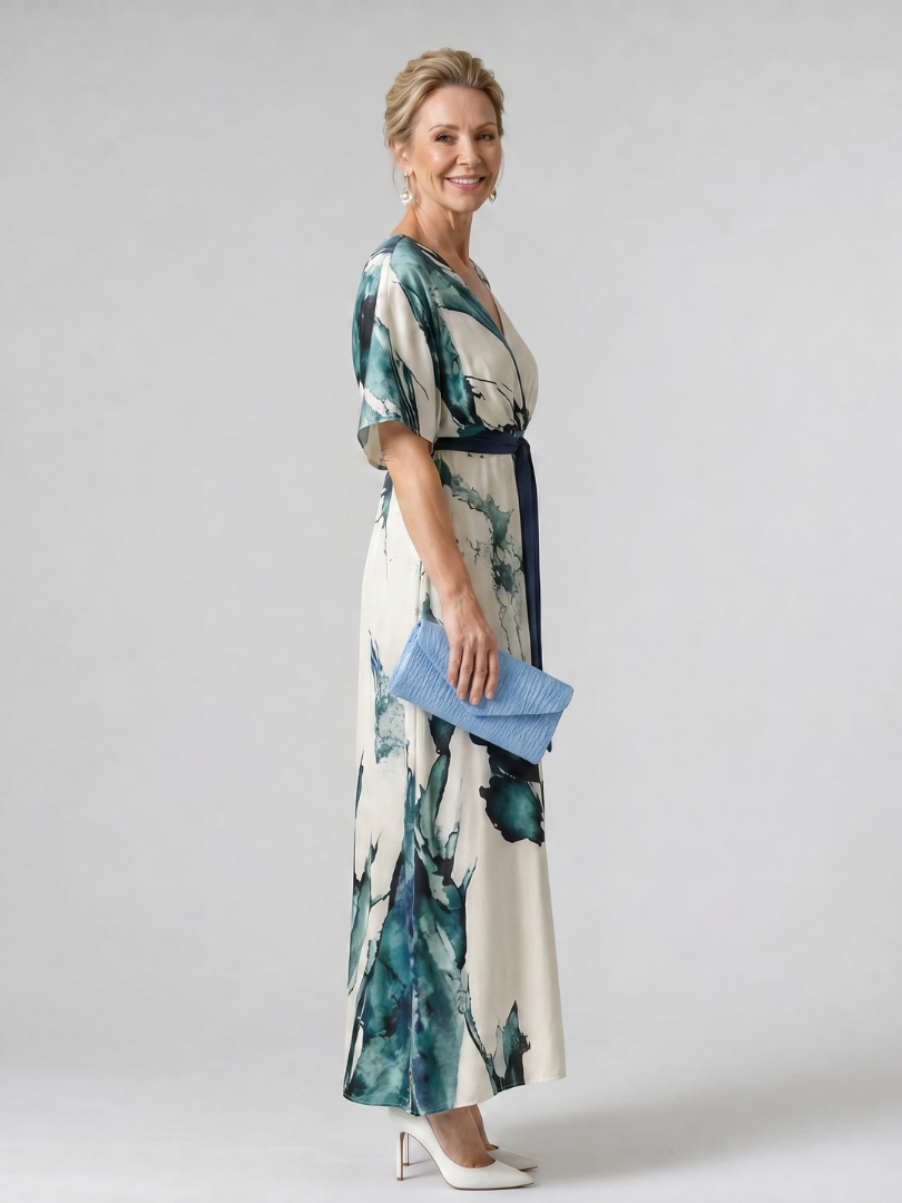 Elegant women's abstract print flowy maxi dress with flutter sleeves & belt. Ideal for summer vacation.