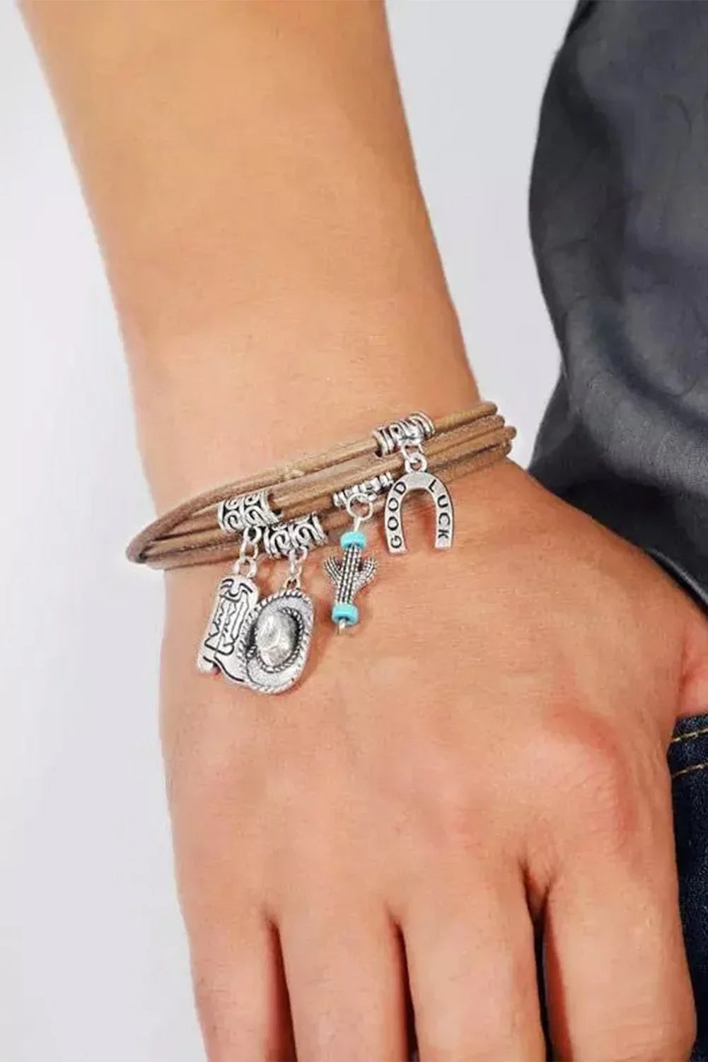 Elegant silver-toned women's western charm bracelet, multi-layered with cowgirl hat & boot accents. Fashion jewelry.