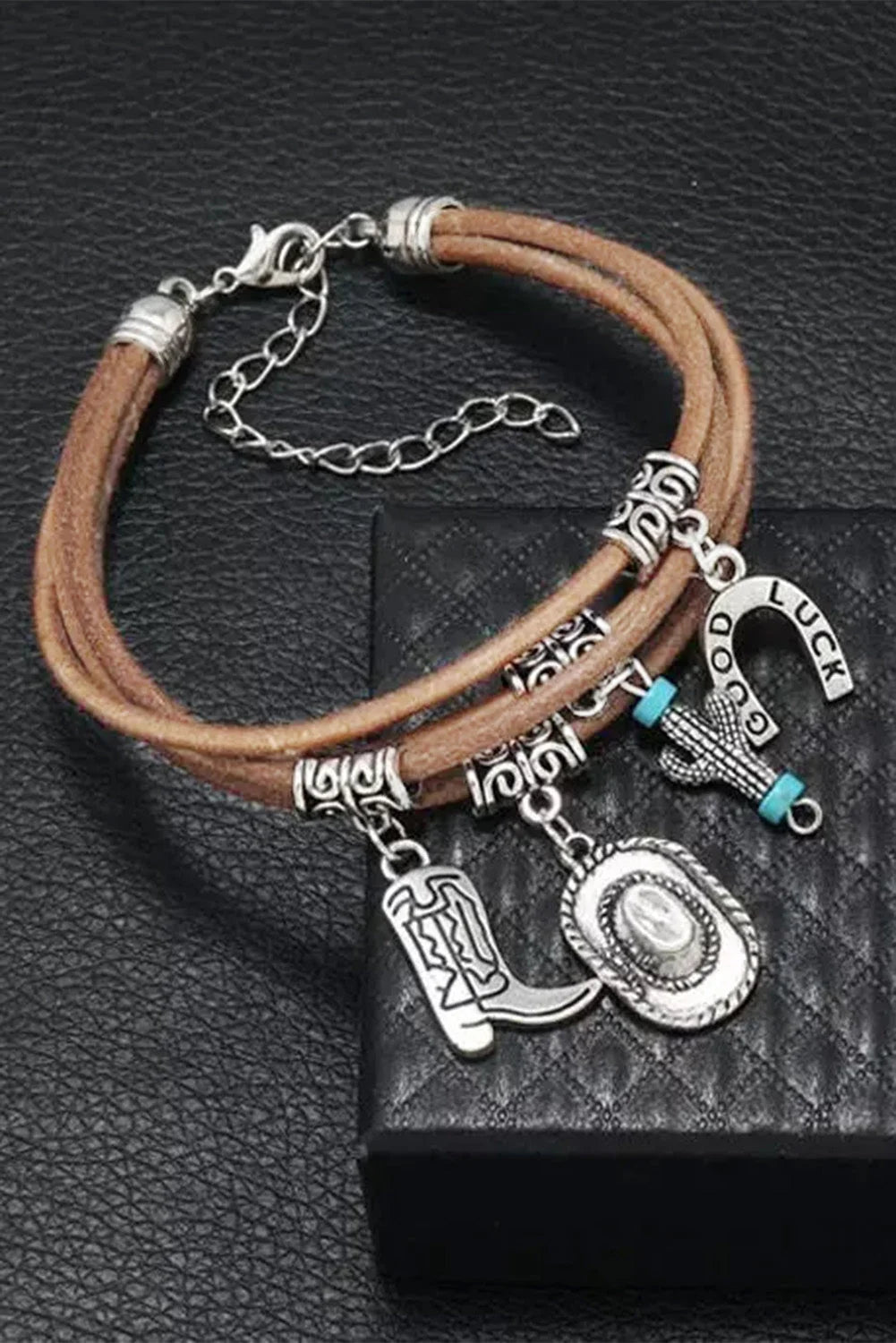 Cowgirl style women's layered bracelet featuring silver boot, hat, & cactus charms. Perfect western fashion accessory.
