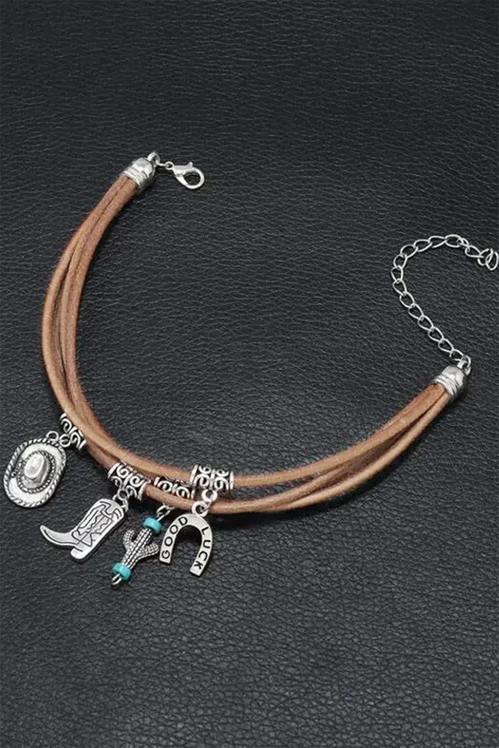 Multi-layered women's western charm bracelet, featuring intricate hat, boot, & cactus charms for cowgirl style.