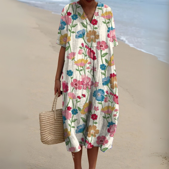 Elegant women's V-neck multicolour midi dress, flowing fabric. Great for summer holidays and events.