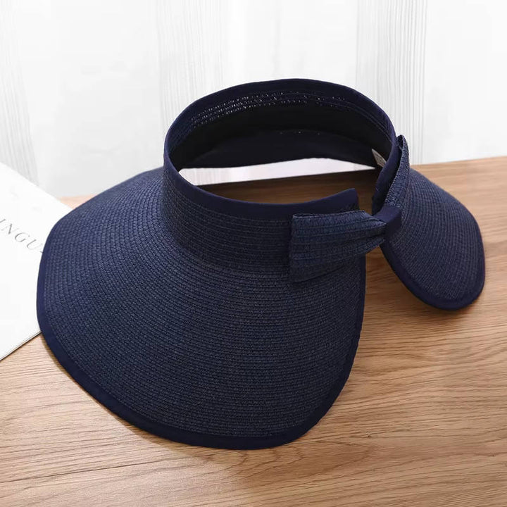 Foldable & adjustable women's straw visor hat with wide brim for summer sun protection.
