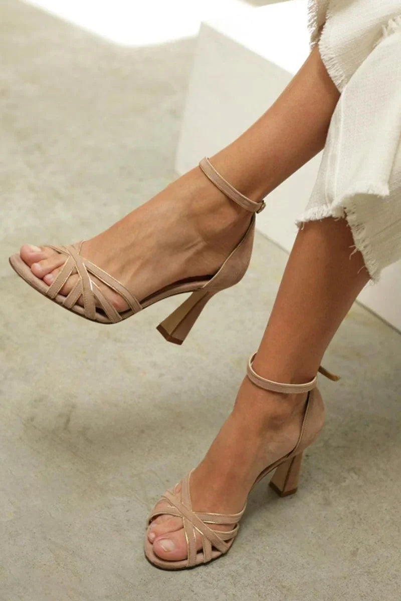 Women's nude strappy open-toe sandals featuring a stylish flared low heel, ideal for elegant summer wear.