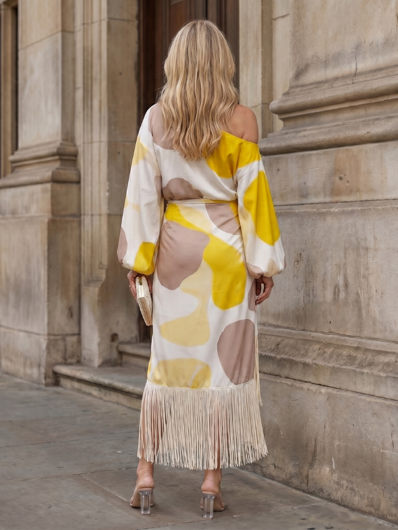 Relaxed fit women's off-shoulder midi dress, featuring a unique abstract print & trendy fringe hem. Ideal for summer.
