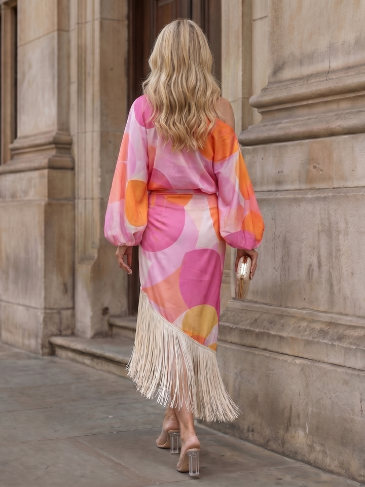 Elegant women's long sleeve off-shoulder midi dress, showcasing a beautiful abstract print and chic fringe hem.