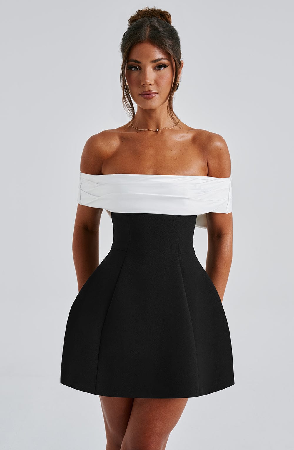 Women's off-shoulder mini dress, flattering flared design & a charming bow back. Great for evening wear.
