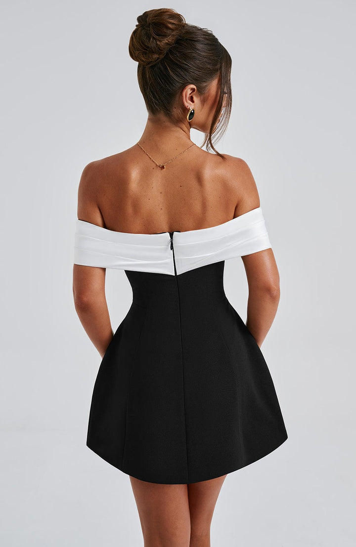 Sophisticated women's off-shoulder flared mini dress, featuring an eye-catching bow back. Cocktail party ready.