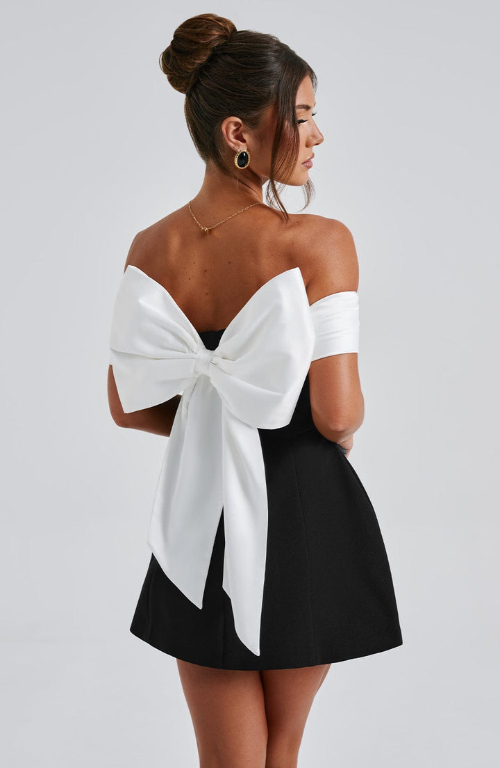 Off-shoulder women's cocktail mini dress, flared style with a distinctive bow back for evening events.