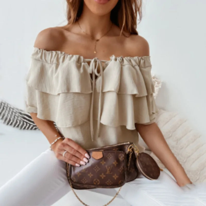 Fashionable women's off-shoulder blouse with long tiered ruffles and a decorative tie-front. Elegant versatile top.