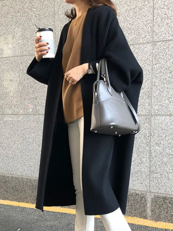 Stylish women's long coat, open front and oversized for a fashionable, cozy, and versatile outerwear option.