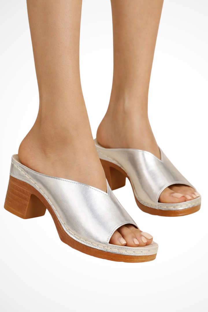 Elegant open toe block heel mules for women. Versatile slip-on heels offering style and comfort.