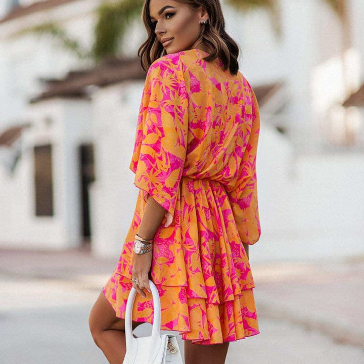 Effortless women's floral mini summer dress with ruffle hem and empire waist, perfect for casual holidays.