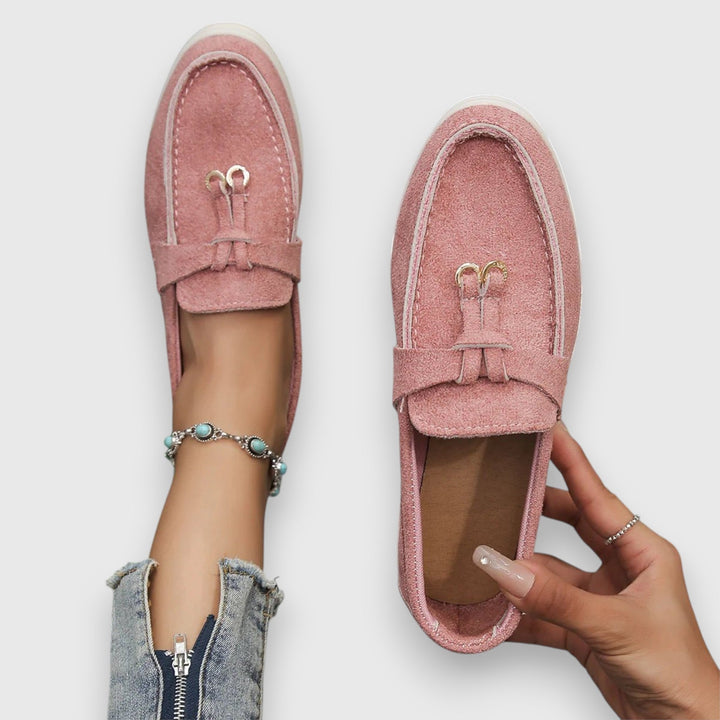 Woman wearing orthopaedic comfort loafers, walking. Supportive slip-on casual footwear for everyday ease.