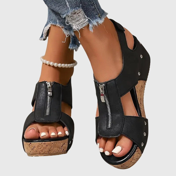 Woman enjoying pain relief & comfort in beige orthopaedic sandals, perfect for daily summer wear.