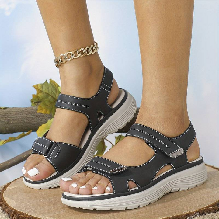 Supportive women's sandals for walking, designed with arch support for foot pain relief.