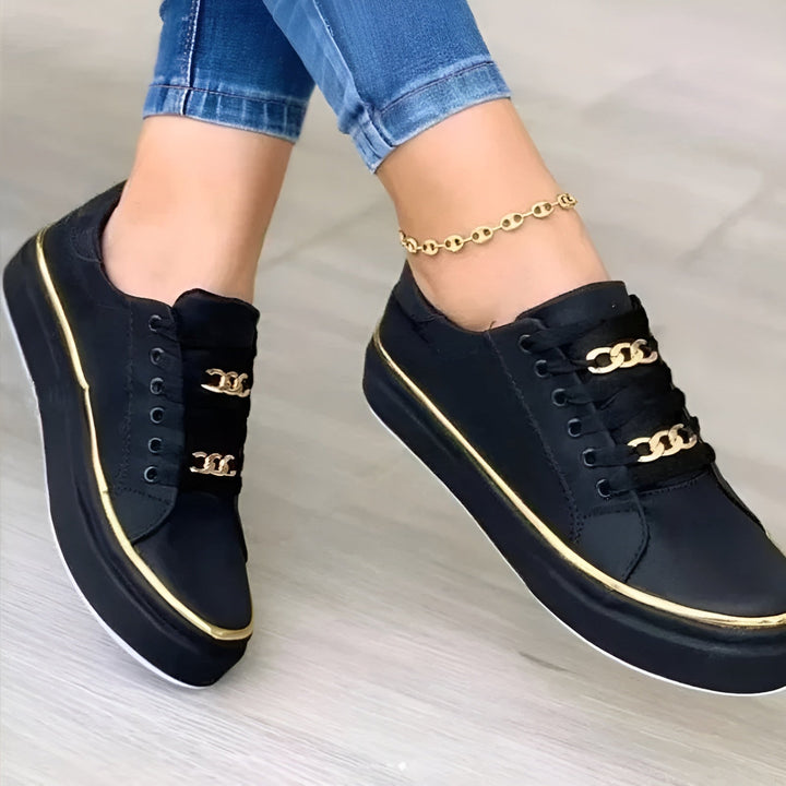 Stylish women's walking shoes with orthopaedic arch support & golden accents, ideal for comfortable daily wear.